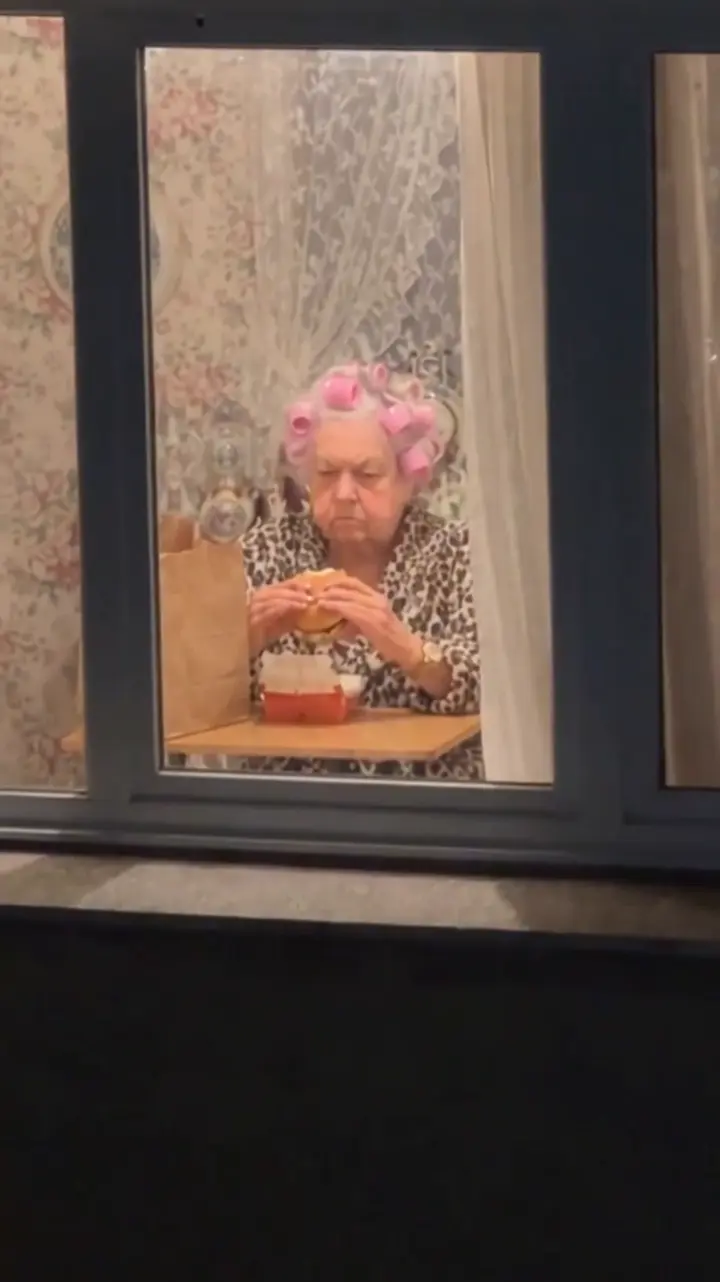 AI-generated Window Peeper result showing an adult eating and looking back through a window