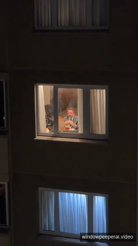 AI-generated opening frame showing a dark apartment building and one lit window